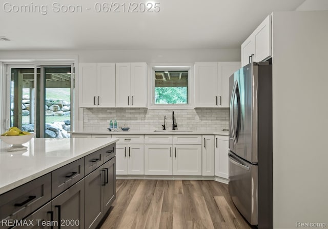 32575 Romsey Rd, Franklin, MI 48025 - kitchen featuring freestanding refrigerator, plenty of natural light, light wood-type flooring, and light countertops