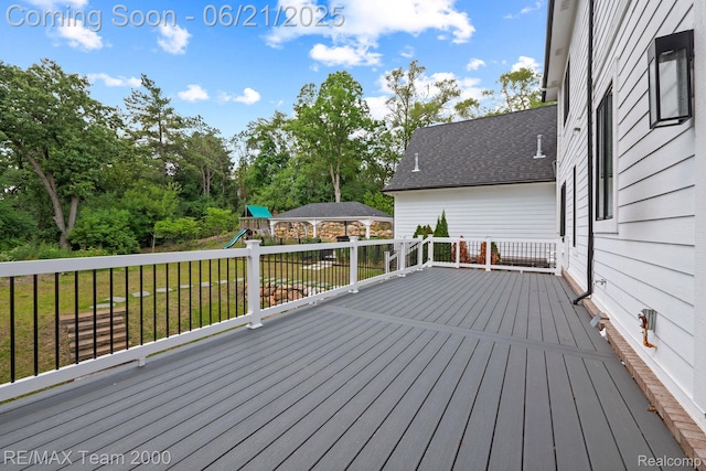32575 Romsey Rd, Franklin, MI 48025 - wooden terrace with a playground, a yard, and view of scattered trees