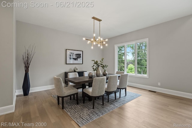 32575 Romsey Rd, Franklin, MI 48025 - dining space featuring a chandelier and light wood-style flooring
