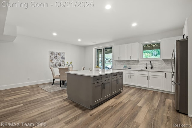 32575 Romsey Rd, Franklin, MI 48025 - kitchen with freestanding refrigerator, white cabinets, gray cabinets, light wood-type flooring, and recessed lighting