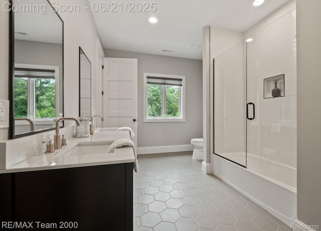 32575 Romsey Rd, Franklin, MI 48025 - full bathroom with double vanity, tile patterned floors, enclosed tub / shower combo, and recessed lighting