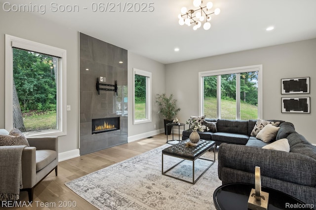 32575 Romsey Rd, Franklin, MI 48025 - living area with plenty of natural light, wood finished floors, a tiled fireplace, and recessed lighting