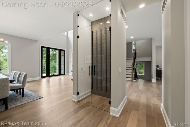 32575 Romsey Rd, Franklin, MI 48025 - corridor featuring light wood-type flooring, stairway, recessed lighting, and a high ceiling