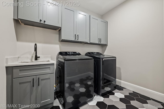 32575 Romsey Rd, Franklin, MI 48025 - laundry area with cabinet space, washer and dryer, and tile patterned floors