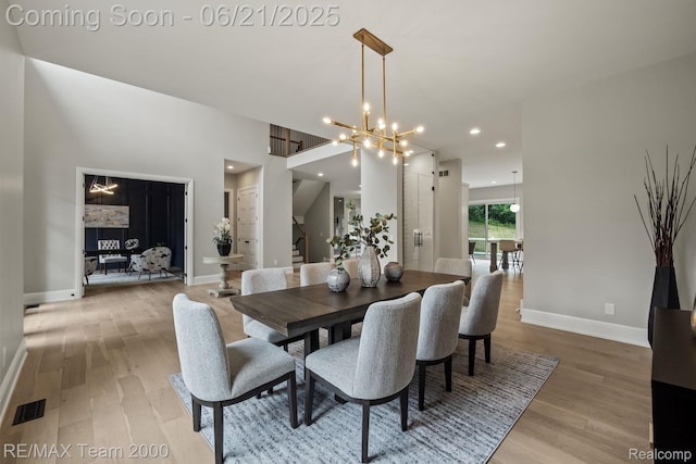 32575 Romsey Rd, Franklin, MI 48025 - dining area featuring light wood-style floors, a chandelier, recessed lighting, and stairway