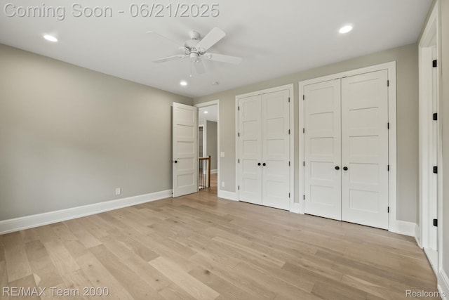 32575 Romsey Rd, Franklin, MI 48025 - unfurnished bedroom featuring two closets, light wood-style floors, recessed lighting, and a ceiling fan