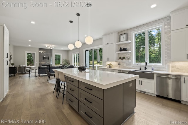 32575 Romsey Rd, Franklin, MI 48025 - kitchen with stainless steel dishwasher, recessed lighting, healthy amount of natural light, and white cabinetry