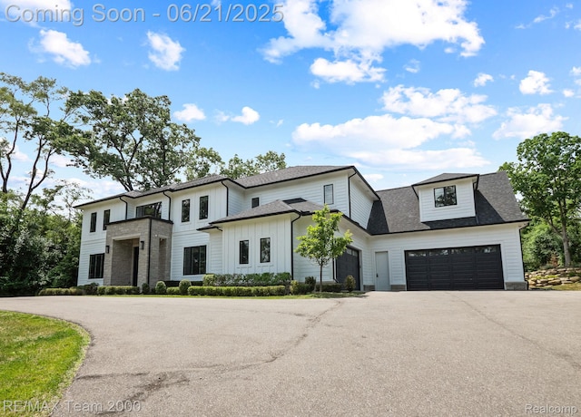 32575 Romsey Rd, Franklin, MI 48025 - modern farmhouse style home with driveway, board and batten siding, roof with shingles, and a garage