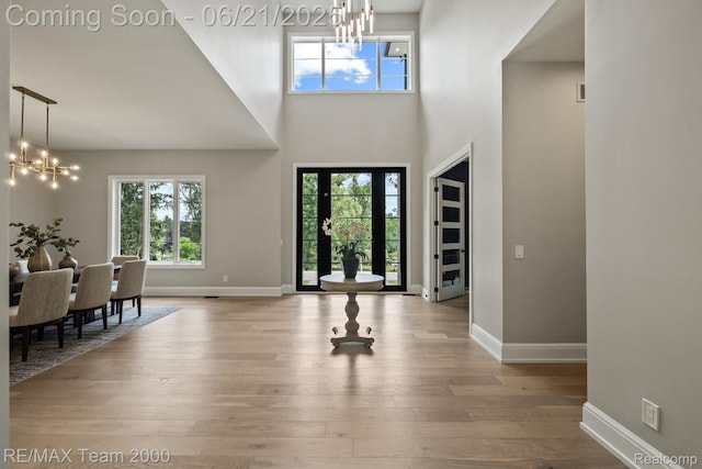 32575 Romsey Rd, Franklin, MI 48025 - entrance foyer featuring a chandelier, wood finished floors, and a high ceiling