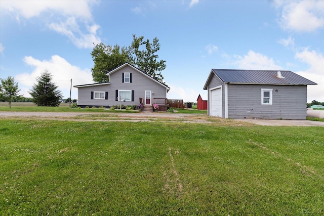 14211 Gilbert Rd, Waldron, MI 49288 - view of property exterior featuring an outbuilding, a yard, a garage, and driveway