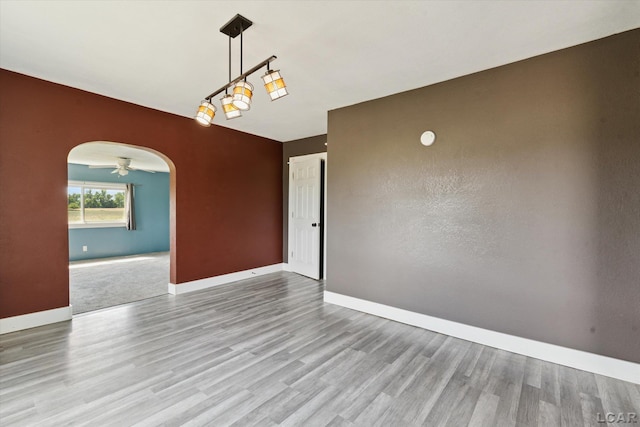14211 Gilbert Rd, Waldron, MI 49288 - spare room featuring arched walkways and wood finished floors