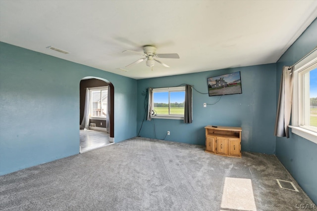 14211 Gilbert Rd, Waldron, MI 49288 - empty room with arched walkways, a ceiling fan, and carpet