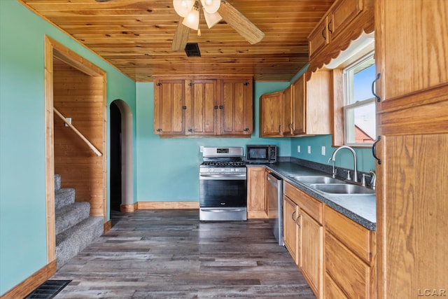 14211 Gilbert Rd, Waldron, MI 49288 - kitchen featuring appliances with stainless steel finishes, wooden ceiling, dark countertops, a ceiling fan, and arched walkways