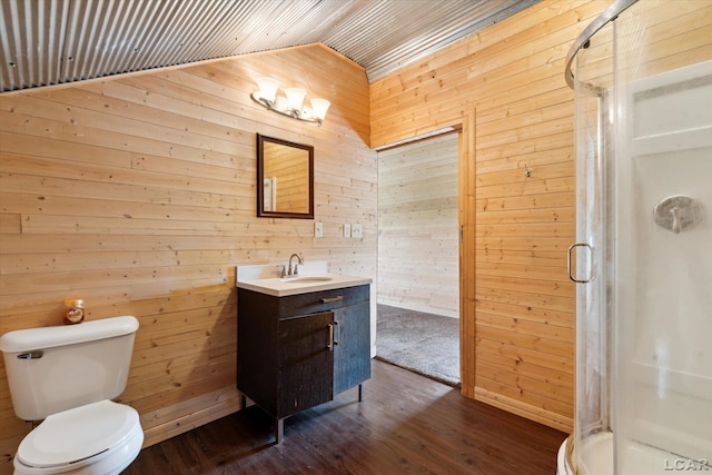 14211 Gilbert Rd, Waldron, MI 49288 - bathroom with wood walls, lofted ceiling, vanity, a shower stall, and wood finished floors