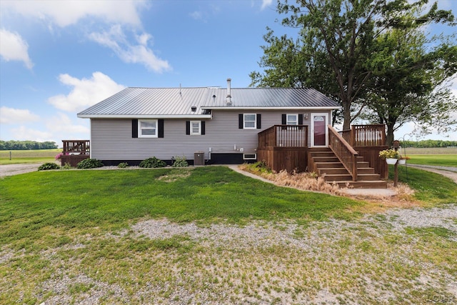 14211 Gilbert Rd, Waldron, MI 49288 - back of house featuring a deck, a metal roof, and a lawn