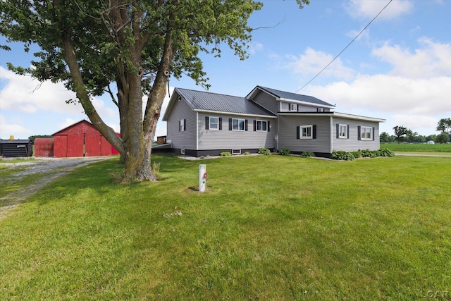 14211 Gilbert Rd, Waldron, MI 49288 - view of front facade with a front lawn, a metal roof, and an outbuilding