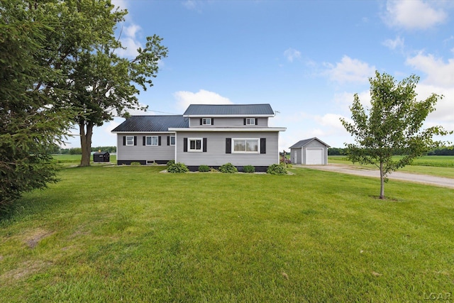 14211 Gilbert Rd, Waldron, MI 49288 - traditional-style home with a garage, an outdoor structure, driveway, a front lawn, and a metal roof