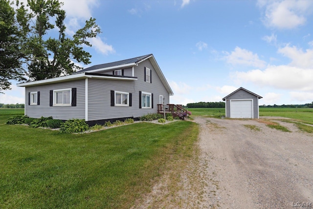 14211 Gilbert Rd, Waldron, MI 49288 - view of side of property with an outbuilding, dirt driveway, a lawn, and a detached garage