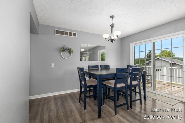 127 Hamilton Ln, Dowling, MI 49050 - dining area with wood finished floors, a chandelier, and a textured ceiling