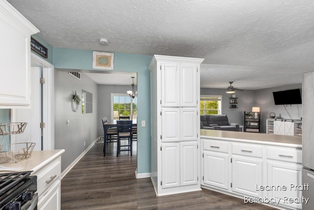 127 Hamilton Ln, Dowling, MI 49050 - kitchen featuring dark wood-style flooring, a ceiling fan, light countertops, range with gas cooktop, and white cabinetry