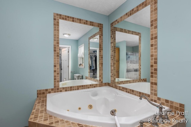 127 Hamilton Ln, Dowling, MI 49050 - full bathroom with a jetted tub and a textured ceiling