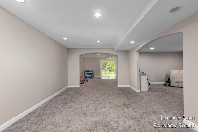 127 Hamilton Ln, Dowling, MI 49050 - spare room featuring arched walkways, carpet floors, and recessed lighting