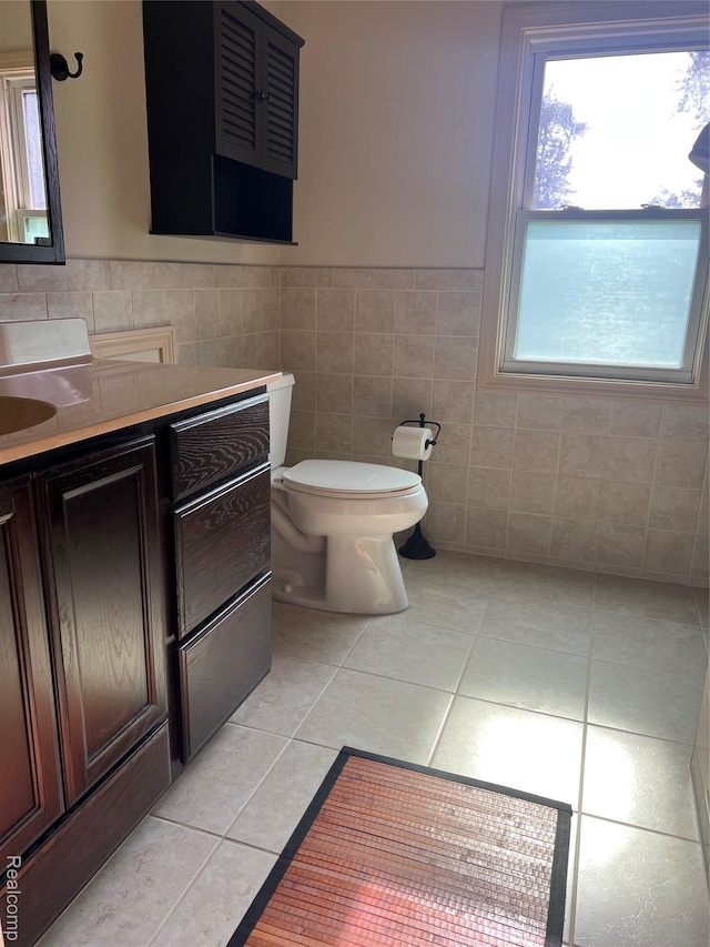 8467 Central St, Center Line, MI 48015 - bathroom with tile patterned floors, tile walls, vanity, and a wainscoted wall