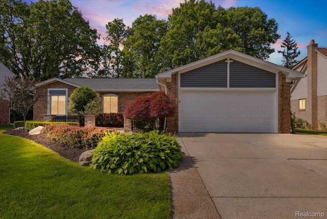 1101 Shallowdale Dr, Troy, MI 48085 - view of front facade featuring concrete driveway, brick siding, a garage, and a yard