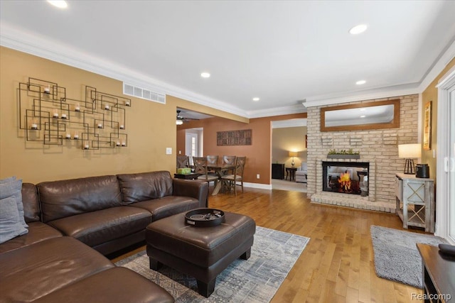 1101 Shallowdale Dr, Troy, MI 48085 - living room with ornamental molding, light wood-style flooring, a brick fireplace, ceiling fan, and recessed lighting