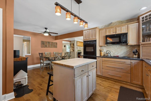 1101 Shallowdale Dr, Troy, MI 48085 - kitchen with black appliances, ceiling fan, backsplash, a kitchen breakfast bar, and light wood-style floors