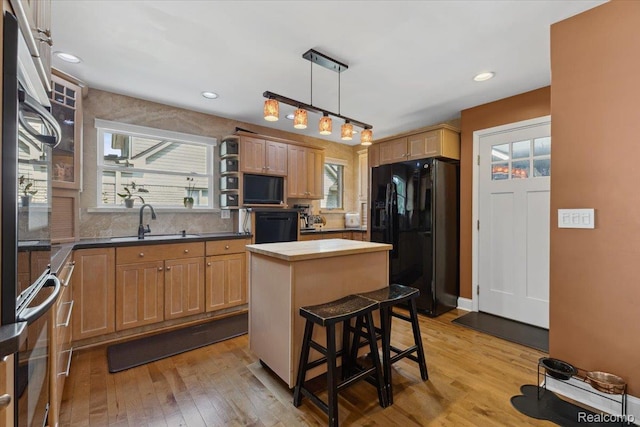 1101 Shallowdale Dr, Troy, MI 48085 - kitchen featuring black appliances, light wood finished floors, a center island, a kitchen bar, and recessed lighting