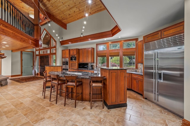 199 E Brooks Rd, Midland, MI 48640 - kitchen with stainless steel appliances, a large island, decorative backsplash, brown cabinets, and recessed lighting