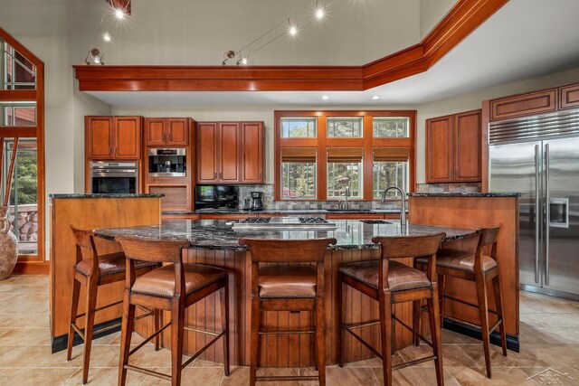 199 E Brooks Rd, Midland, MI 48640 - kitchen with appliances with stainless steel finishes, brown cabinetry, backsplash, dark stone counters, and ornamental molding
