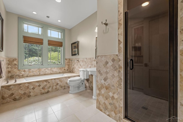 199 E Brooks Rd, Midland, MI 48640 - bathroom with tile walls, recessed lighting, a bath, tile patterned floors, and a wainscoted wall
