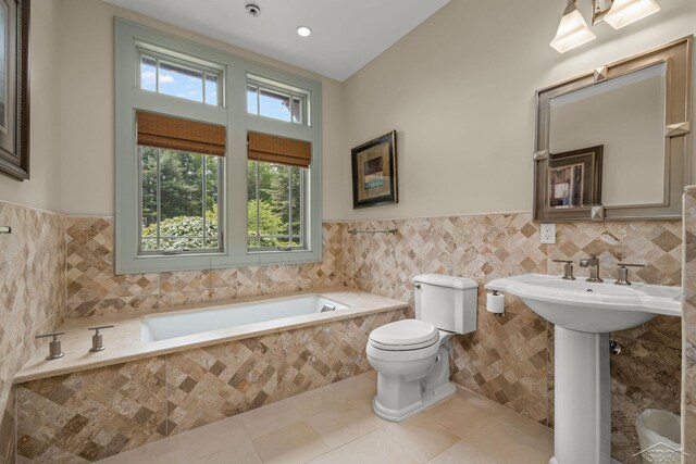199 E Brooks Rd, Midland, MI 48640 - bathroom with tile walls, a bath, a wainscoted wall, and tile patterned floors