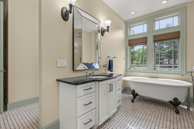 199 E Brooks Rd, Midland, MI 48640 - bathroom with vanity, a freestanding tub, recessed lighting, and tile patterned floors