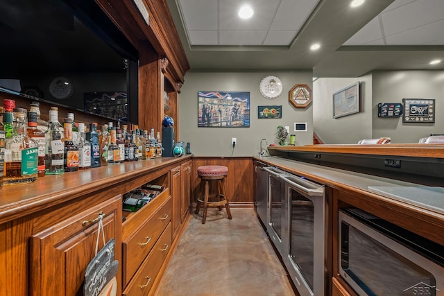 199 E Brooks Rd, Midland, MI 48640 - indoor wet bar with beverage cooler, stainless steel microwave, wainscoting, and wooden walls