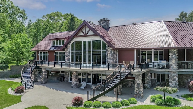 199 E Brooks Rd, Midland, MI 48640 - rear view of property with stairway, stone siding, a chimney, a patio area, and a carport