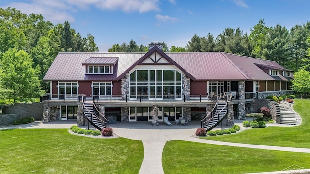 199 E Brooks Rd, Midland, MI 48640 - back of house with stairway, stone siding, and a chimney