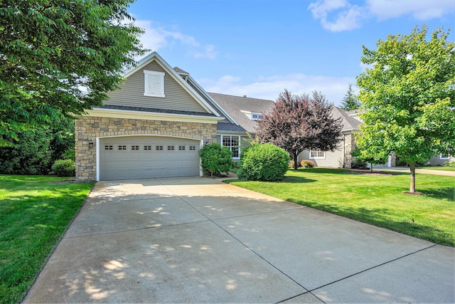 8842 Oakland Hills Cir, Portage, MI 49024 - view of front of property featuring stone siding, driveway, a front yard, and a garage