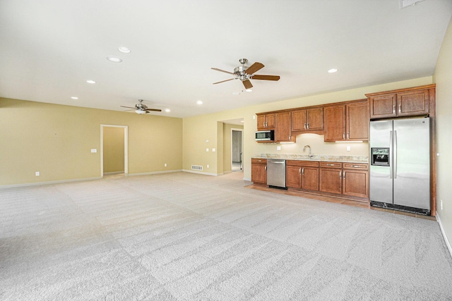 8842 Oakland Hills Cir, Portage, MI 49024 - kitchen featuring appliances with stainless steel finishes, ceiling fan, light countertops, recessed lighting, and light colored carpet