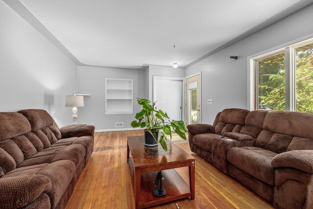 3050 Sharon Ave SW, Wyoming, MI 49519 - living room featuring built in features and wood finished floors