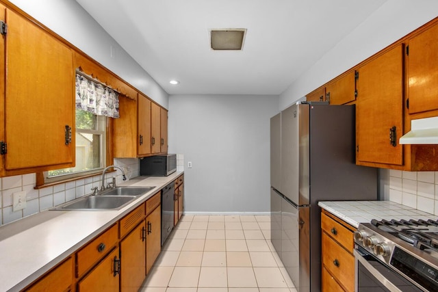 3050 Sharon Ave SW, Wyoming, MI 49519 - kitchen with appliances with stainless steel finishes, decorative backsplash, light countertops, recessed lighting, and brown cabinets