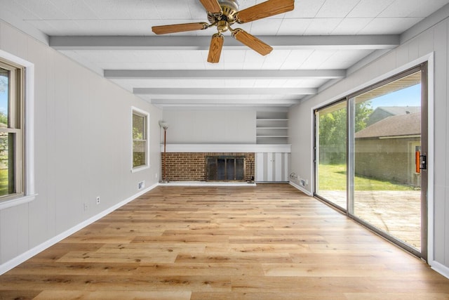 3050 Sharon Ave SW, Wyoming, MI 49519 - unfurnished living room featuring light wood-style flooring, beamed ceiling, a brick fireplace, and ceiling fan