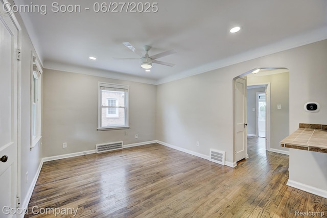 830 W Hazelhurst St, Ferndale, MI 48220 - empty room featuring arched walkways, a ceiling fan, wood finished floors, crown molding, and recessed lighting