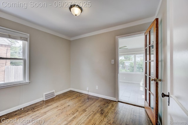 830 W Hazelhurst St, Ferndale, MI 48220 - empty room featuring wood finished floors and ornamental molding