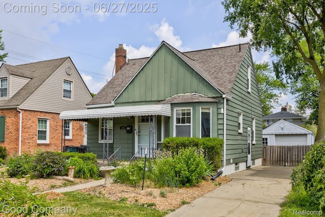 830 W Hazelhurst St, Ferndale, MI 48220 - bungalow with covered porch, board and batten siding, a shingled roof, a garage, and a chimney