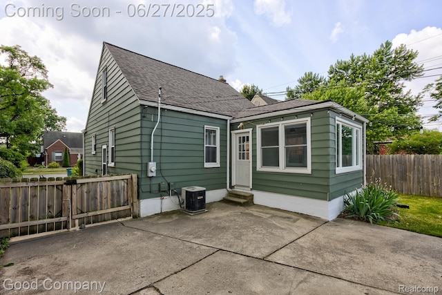 830 W Hazelhurst St, Ferndale, MI 48220 - back of property featuring entry steps, a patio area, and a shingled roof