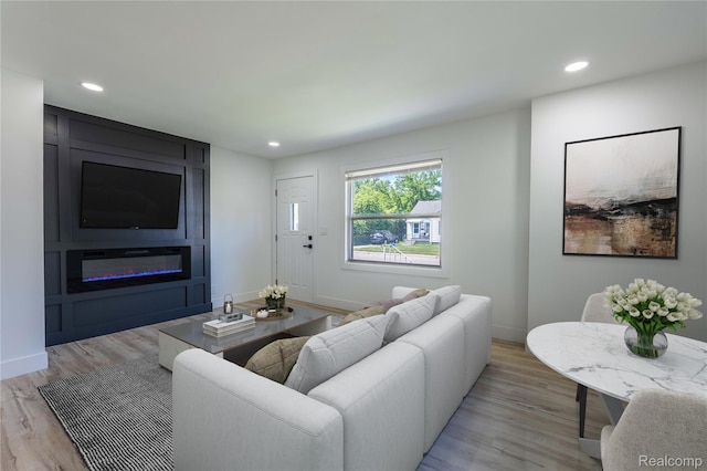 19228 Melvin St, Roseville, MI 48066 - living area featuring a large fireplace, light wood-style flooring, and recessed lighting