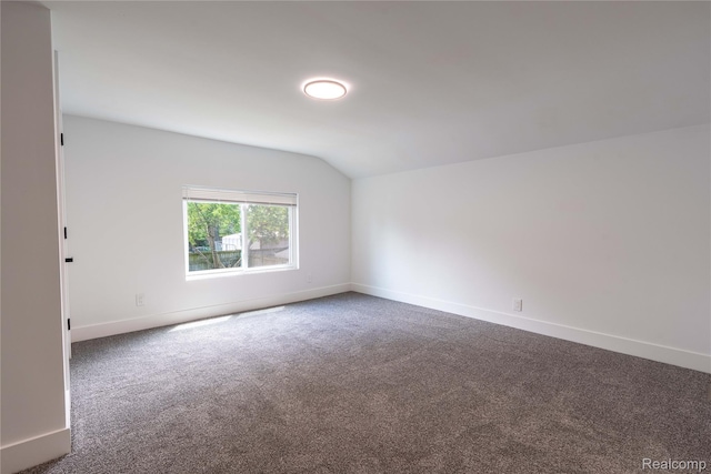 19228 Melvin St, Roseville, MI 48066 - spare room featuring lofted ceiling and dark colored carpet